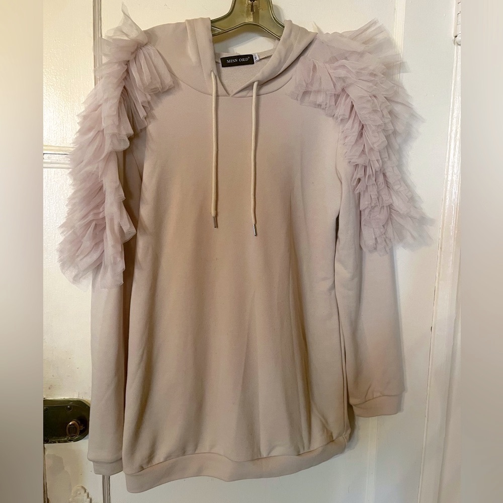 Very unique dressy hoodie.Ruffles on the shoulder perfect condition never worn